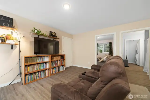From entry way looking through living area to door from garage, first bedroom and main bathroom (w/laundry)