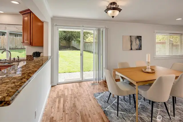 Sliding glass doors that open to the newly landscaped, fully fenced backyard.