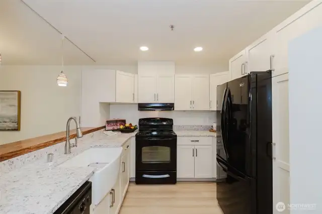Bright, updated kitchen with quartz counters, farm sink.