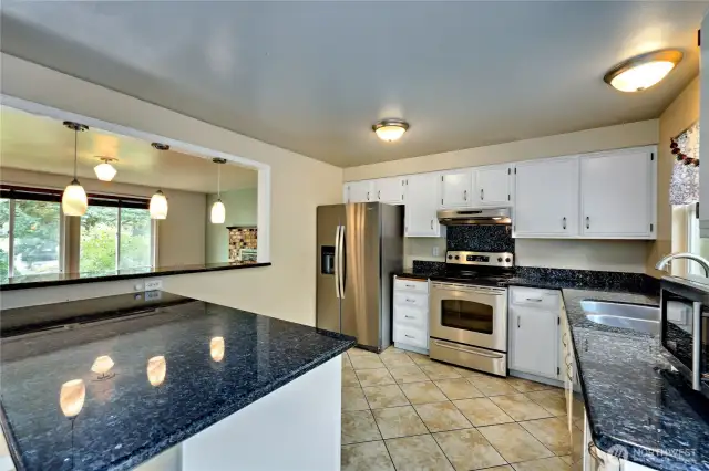 Love this kitchen!  Granite countertops and open to the living room.  French doors lead to expansive back deck with access to the backyard.