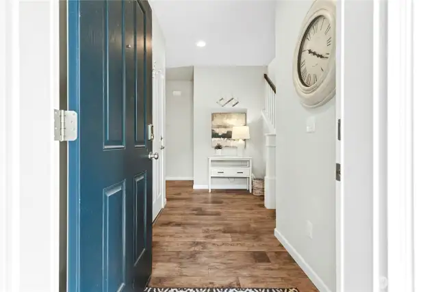 Wide entry with storage under the stairway.