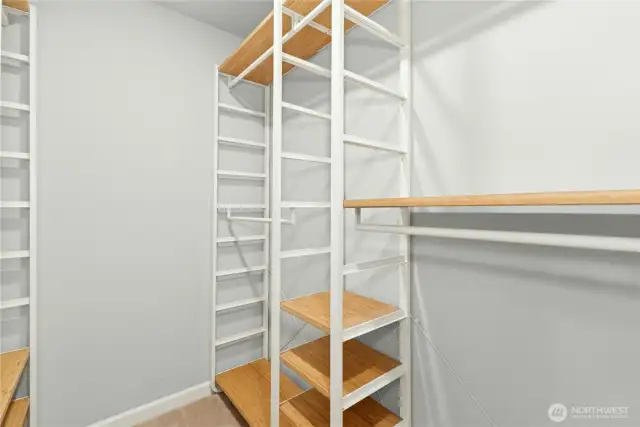 Huge walk-in primary closet with adjustable shelving.