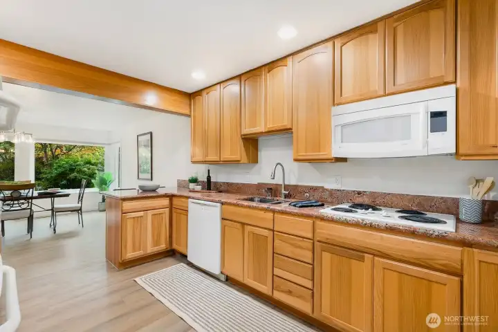 Open sight lines from kitchen to dining area and private patio beyond.