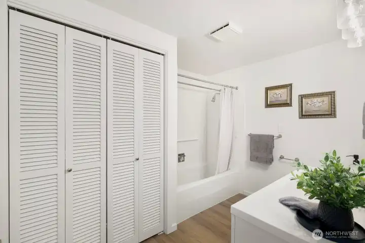 Spacious full bath with refreshed vanity, lighting, and durable LVP flooring.