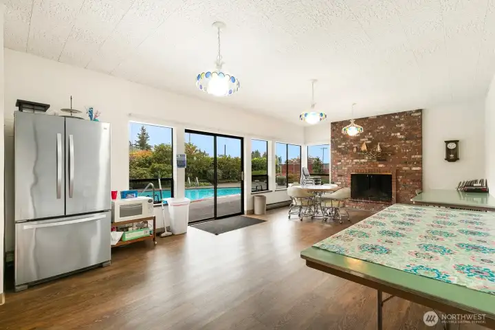 Spacious community room with kitchen, lounge area, and direct pool access complete with bathrooms and showers.