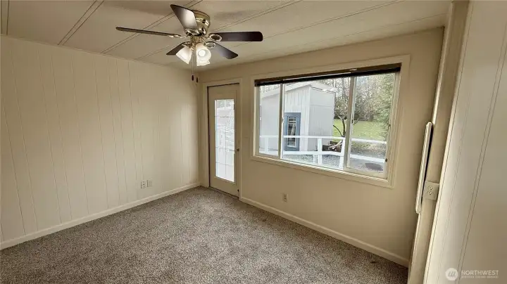 Guest bedroom with door leading to deck