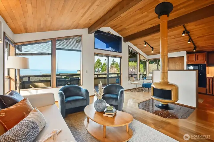 Upper level family room gathering space with original Malm fire stove  - the adjacent to kitchen and large view deck