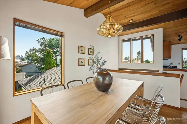 Lovely dining room with big windows and views down the grad 3-story entry stairs