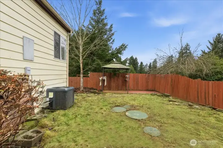 Back yard with newer heat pump