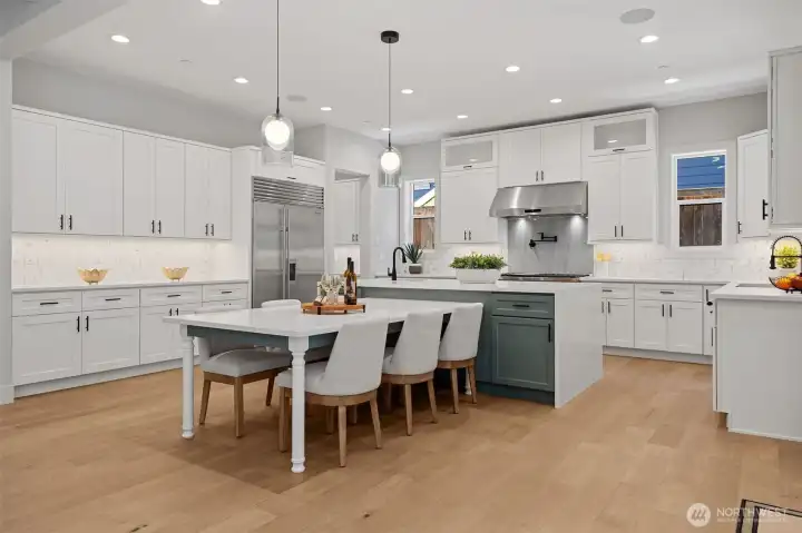 Storage is easy with a wall of custom cabinetry, and a Subzero refrigerator/freezer and a community table where everyone can gather at mealtime or for special   projects.