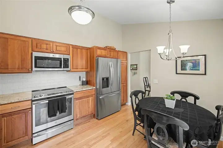 Kitchen with cherry cabinets and stainless steel appliances.