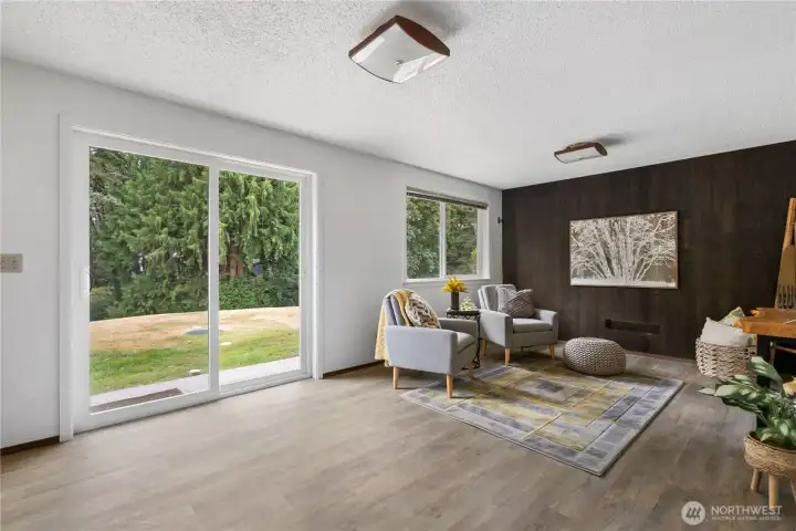 Downstairs living space with sliding door leading to front yard and 1 of 2 driveways. Downstairs living space with sliding door leading to front yard and 1 of 2 driveways.