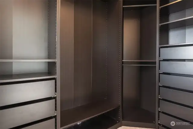 Walk-in primary closet with built-ins.