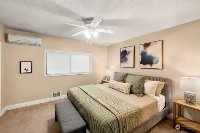 Main level bedroom features ductless heating and air conditioning and a walk in closet.