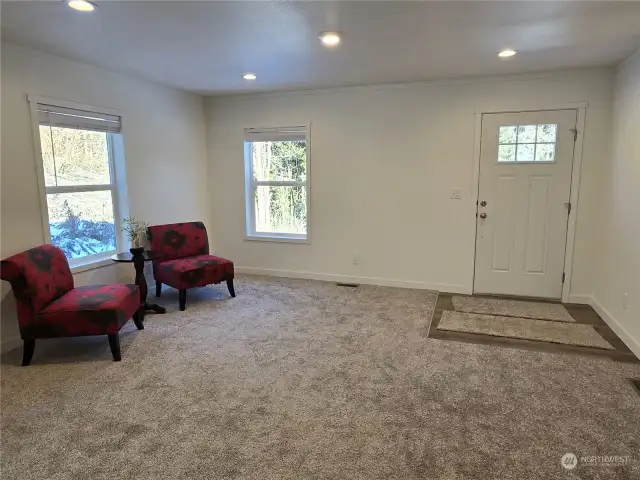 Spacious living room with recessed LED lighting.