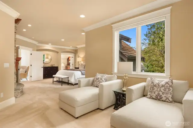 Primary Suite sitting alcove with Juliette balcony and custom bookcase/display cabinetry