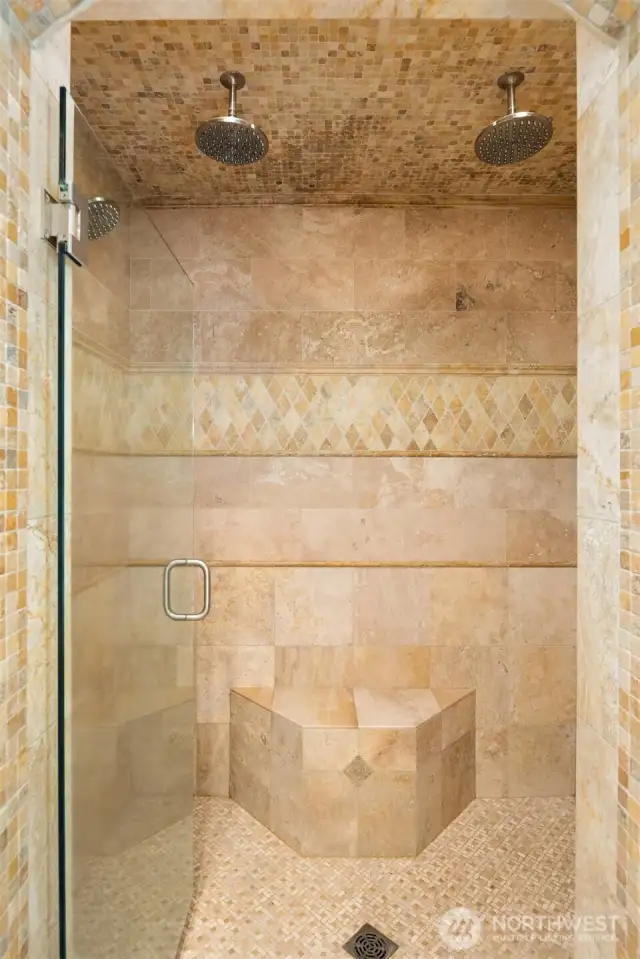 Stone encased shower with designer accents and seating