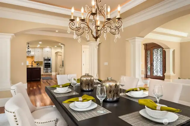 Formal Dining with beaded Italian chandelier and tray ceiling with accent lighting