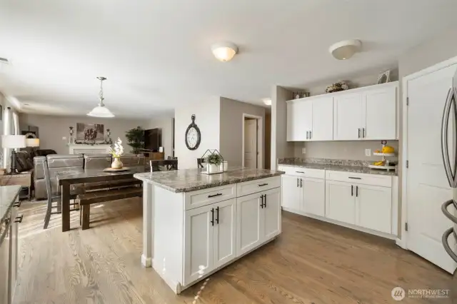 This great room is open and spacious! Gorgeous, updated kitchen is the hub of this home! Fresh White Shaker cabinets and slab granite counters!
