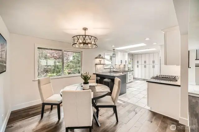 Dining area off kitchen w/ modern light fixtures