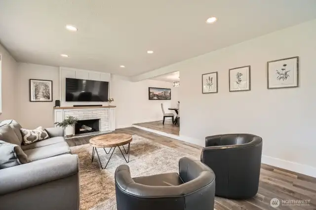 Spacious main floor living room w/ wood burning fireplace