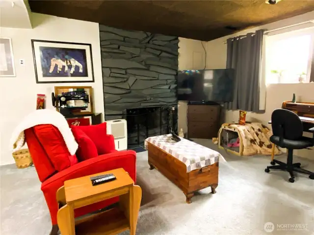 Versatile bonus room with wood fireplace.