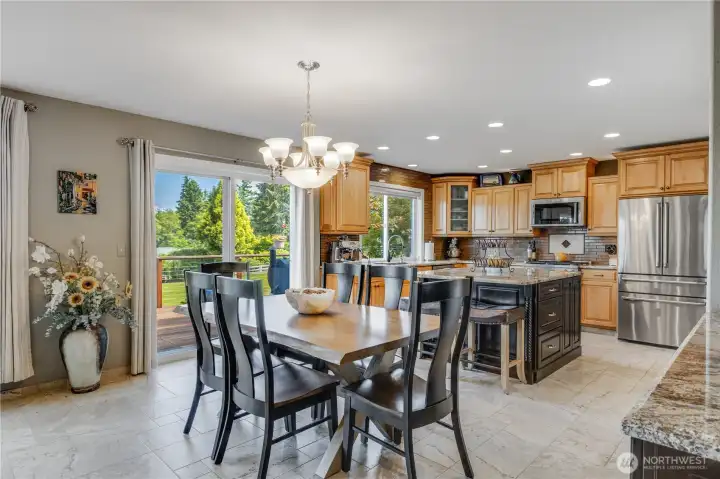 Large sliding door off dining area leads to expansive back patio perfect for entertaining