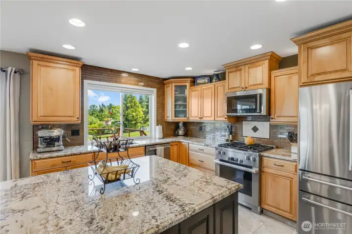 Large kitchen features beveled granite countertops, maple cabinets & ambient lighting below and above. Large kitchen features beveled granite countertops, maple cabinets & ambient lighting below and above.