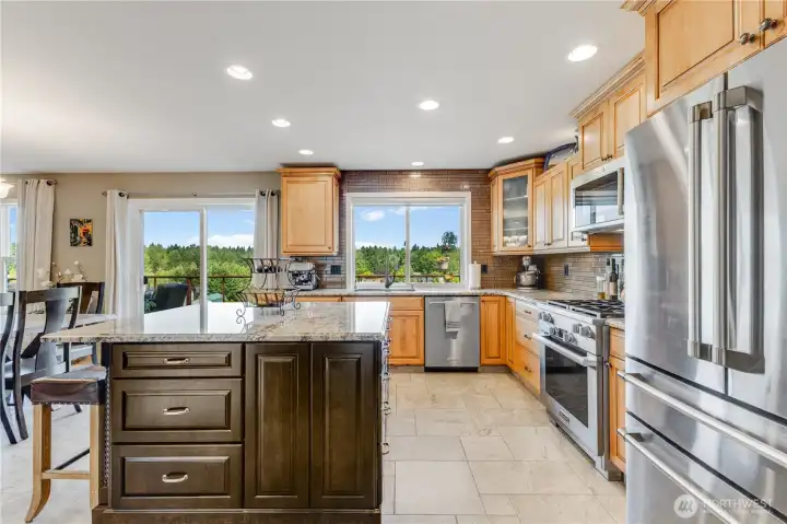 Kitchen island has extra storage and can sit 3 comfortably. You have views of the mountain while washing dishes. Fridge is brand new Cafe Brand