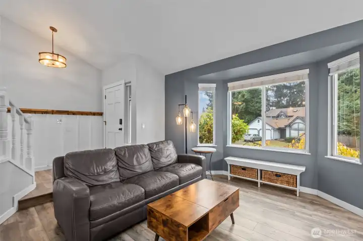 Bright and inviting living area featuring vinyl plank hardwood floors and an open flow.