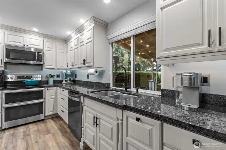 From the sink you can enjoy the view of the park-like backyard.