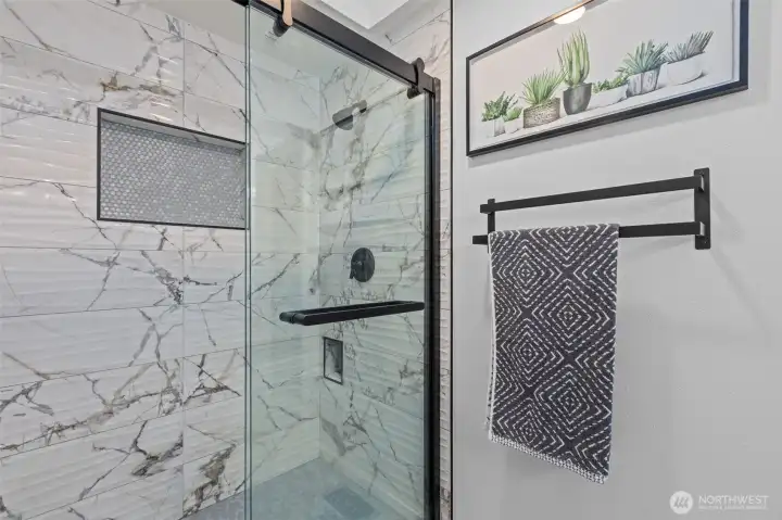 Large double walk-in shower with beautiful tile.