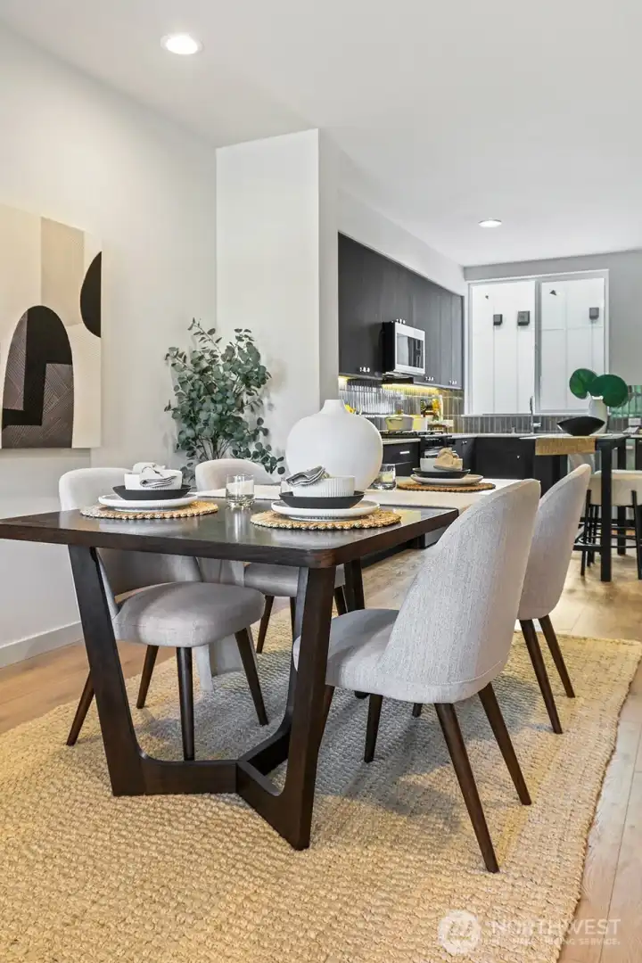 The dedicated dining space is ready for dinner parties or cozy nights, blending seamlessly into the heart of the home.