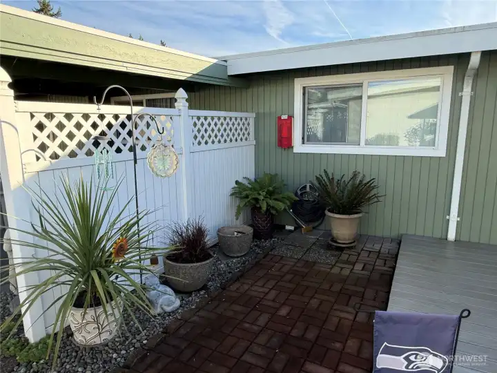 This brick patio is just off the deck and this fence divides the two patio areas from each other.
