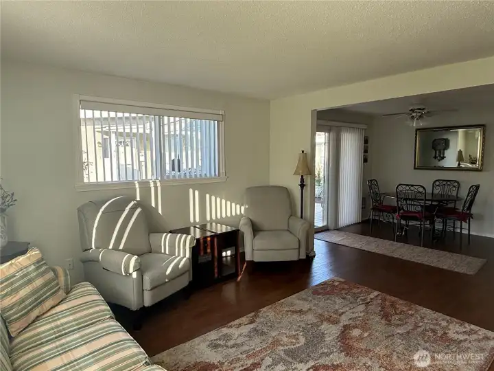 Living room open to dining room and sliding glass door leading to the covered deck.