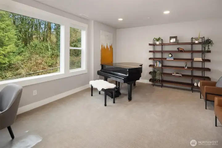 Large bonus room with high ceilings, french doors, and greenbelt views