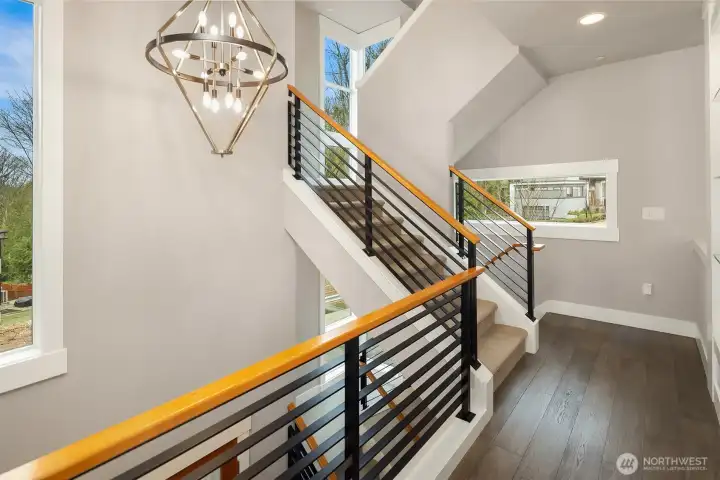 modern railings, high ceilings, beautiful hardwood and upgraded carpet!