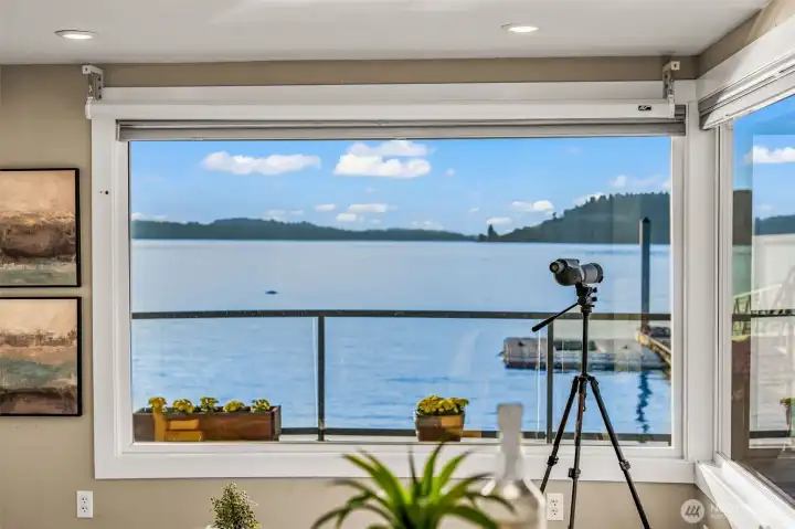 Expansive windows frame panoramic water views — the Sound is your everyday backdrop.
