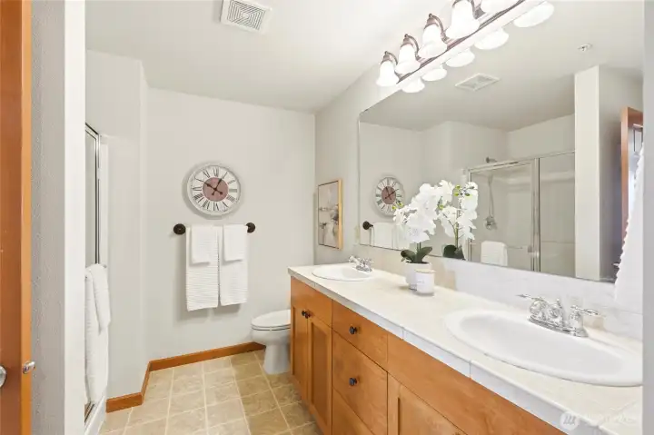 Primary Bathroom with walk in shower and dual sink vanity.