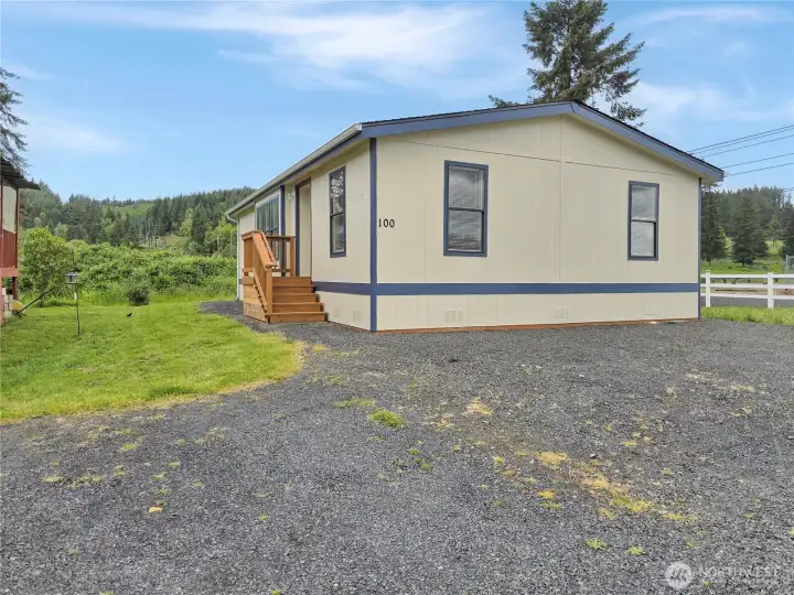 New porches and skirting complement the freshly painted exterior.