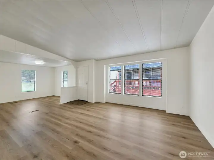Half wall design adds definition between the living room and den area.