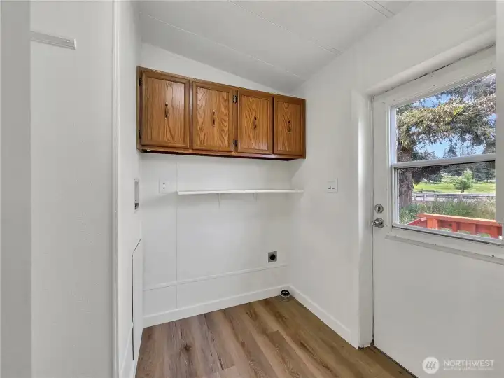 Dedicated laundry room with added storage and exterior access.