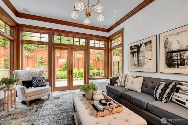 Atrium surrounded by windows and French Doors to patio/backyard.