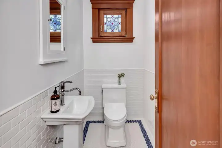 Main floor Powder Room with stained glass window.