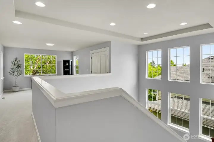 Light-filled stairwell leads to a spacious loft.