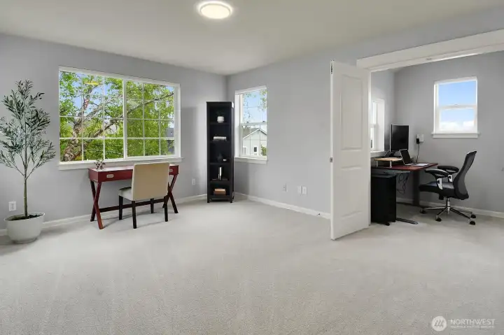 View of the loft with cozy office nook with french doors.