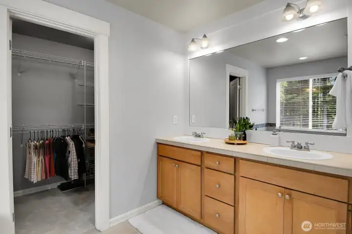 Primary vanity and walk-in closet.
