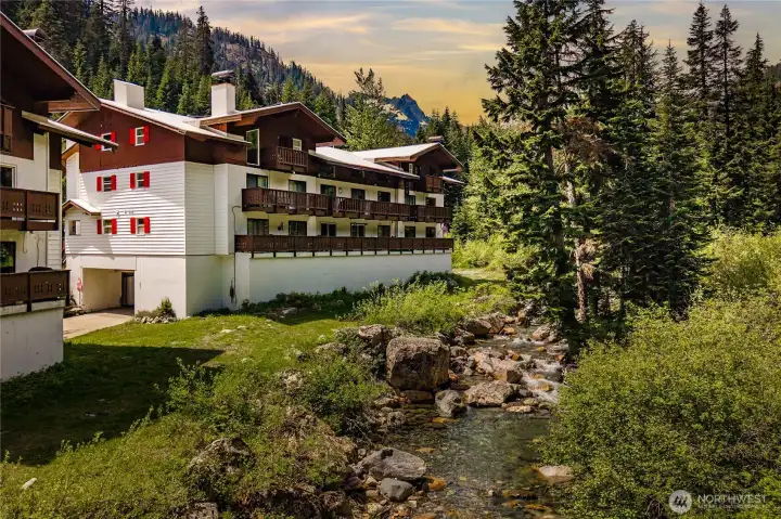 Streamside mountain living at its best—enjoy the soothing sounds of the creek, towering evergreens, and stunning alpine scenery right outside your door.