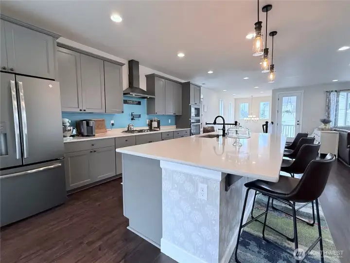 Crisp black stainless appliances and hood
