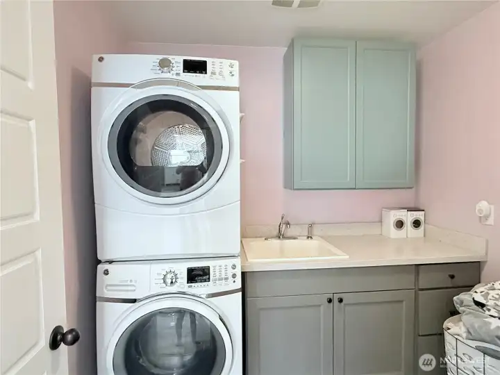 Upstairs, stacking laundry units stay with home